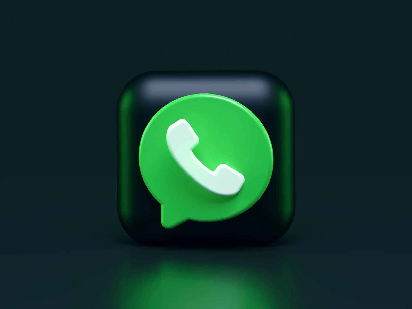 A green WhatsApp speech bubble icon on a dark background