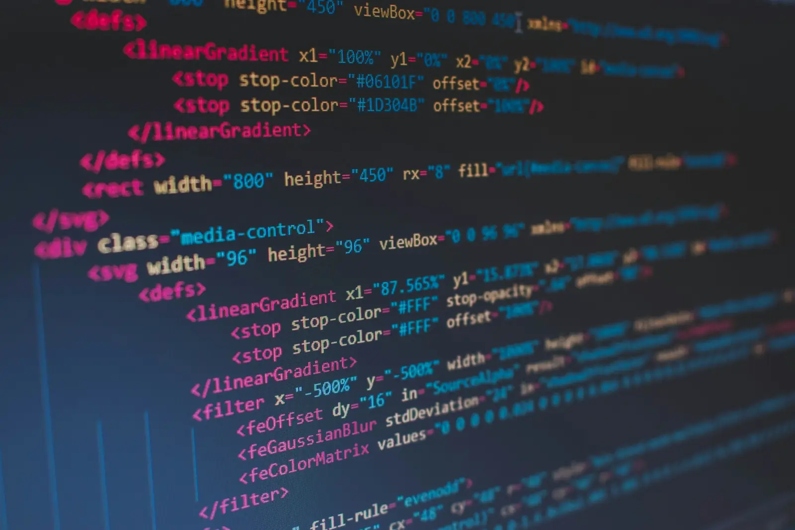 Lines of colourful HTML code in an editor on a dark screen