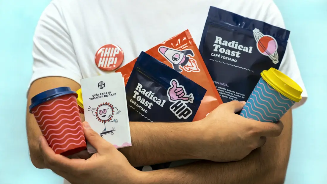 Branded coffee bags, cups and stickers held together, all in one colourful identity